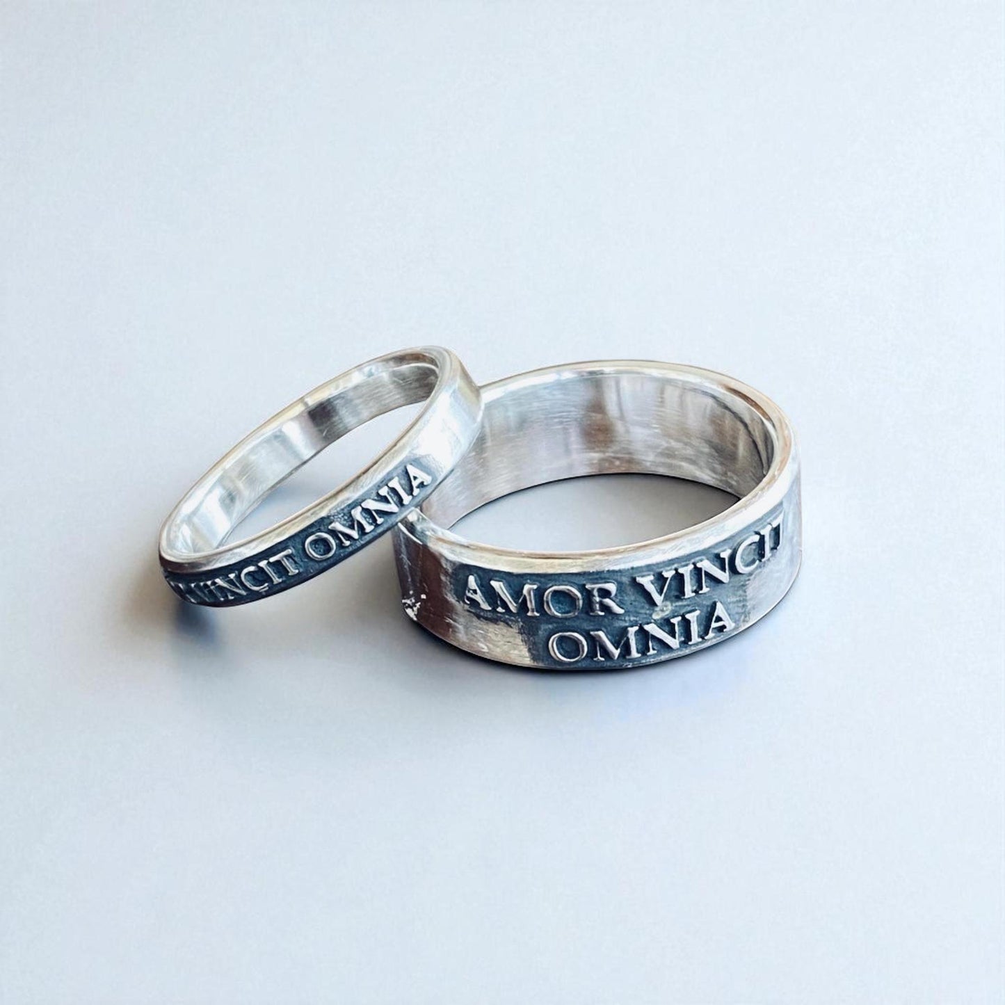 Matching thin and wide Amor Vincit Omnia rings