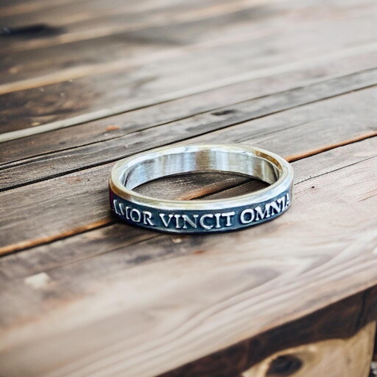 Amor Vincit Omnia thin sterling silver ring with raised lettering