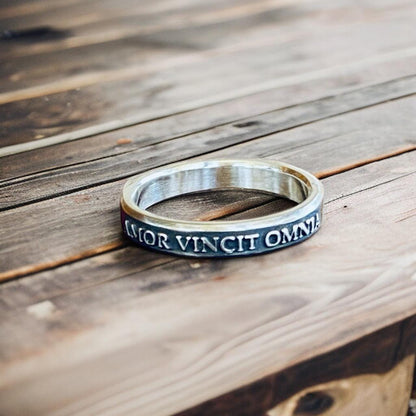 Amor Vincit Omnia thin sterling silver ring with raised lettering