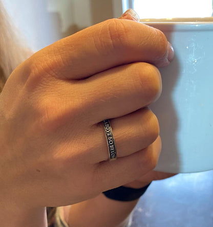 Thin As Above So Below sterling silver ring worn on a finger