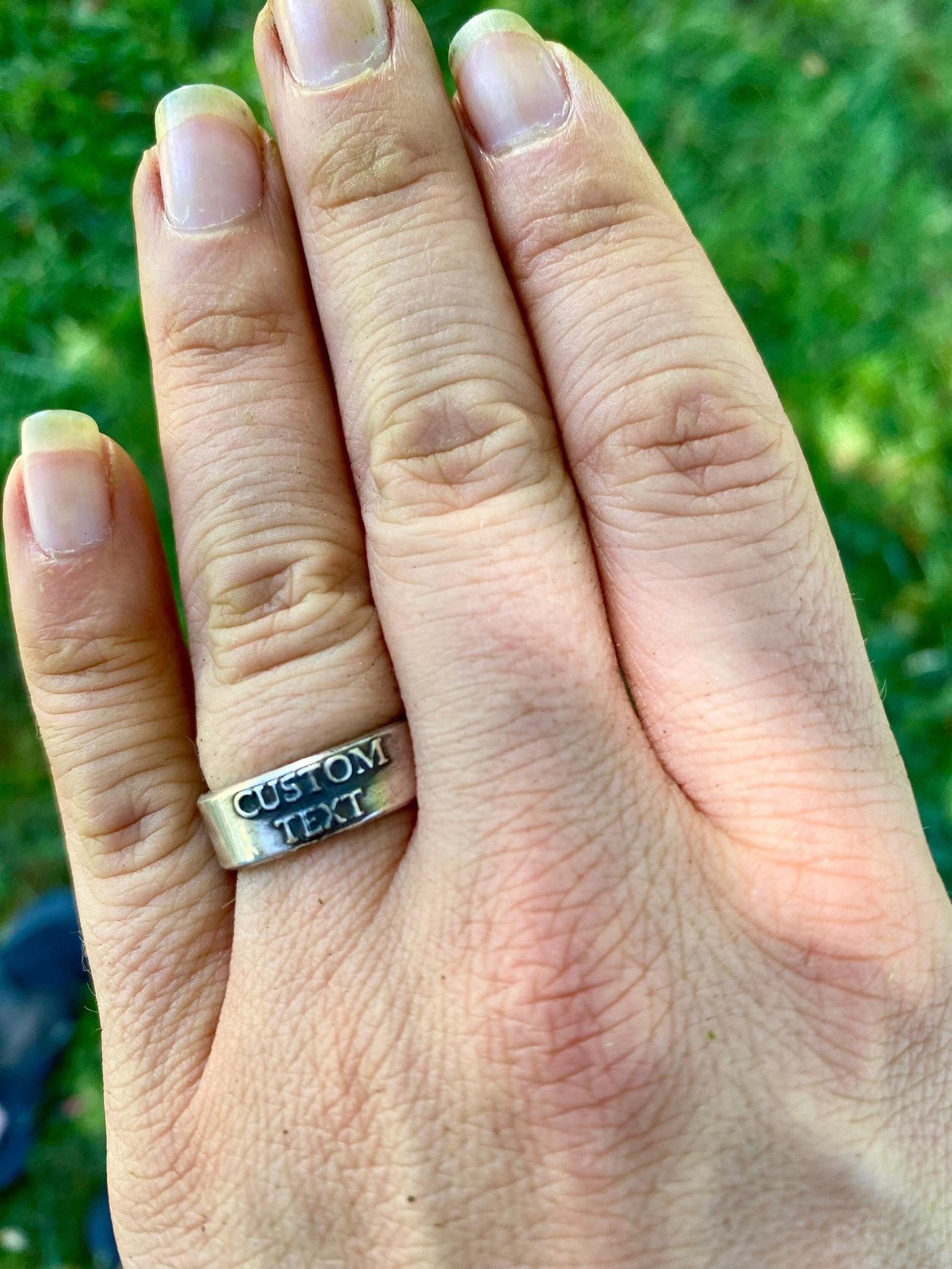 Personalized sterling silver band with raised custom text