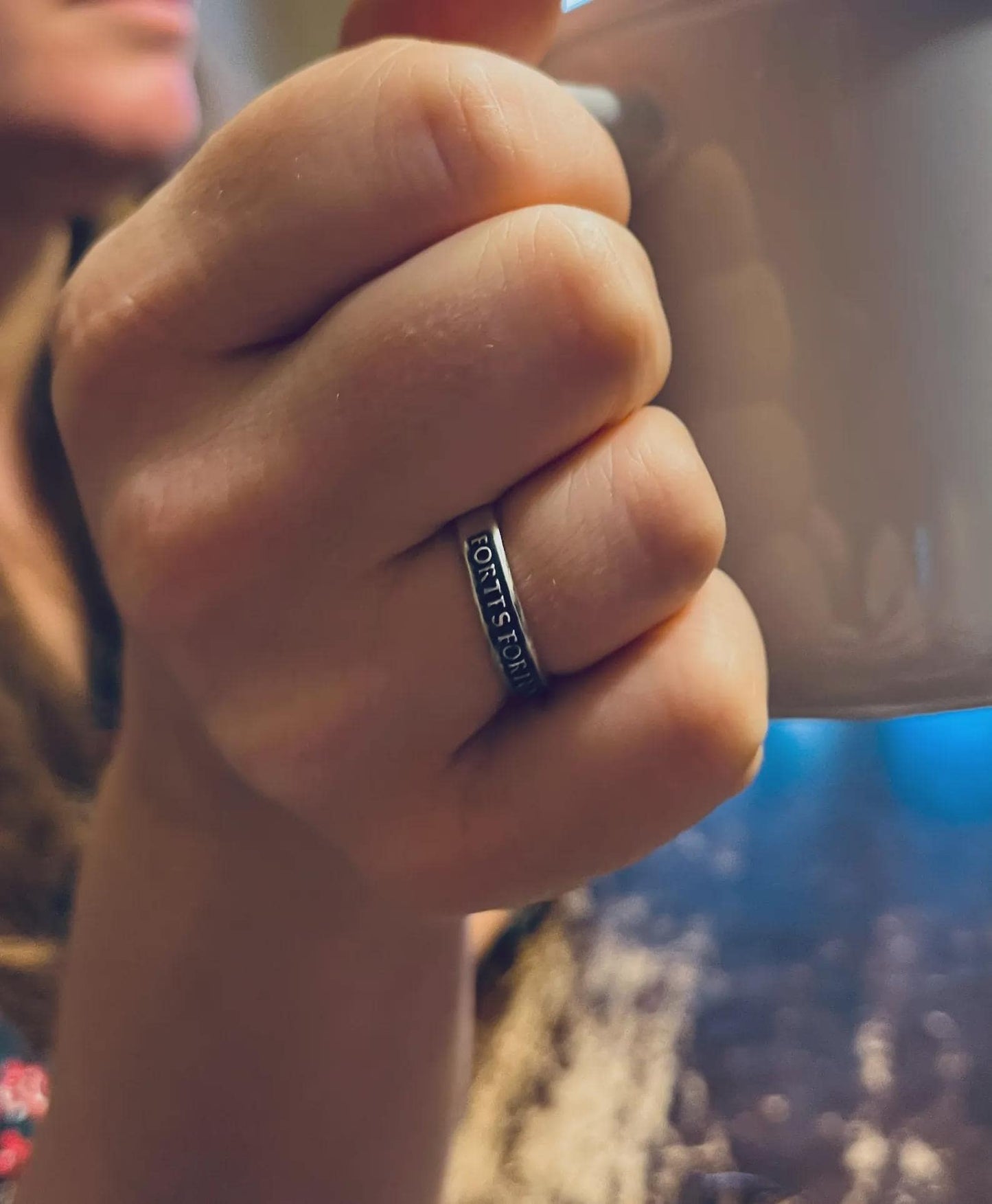 Thin Fortes Fortuna Adiuvat sterling silver ring worn on a finger