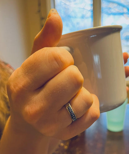 Fortes Fortuna Adiuvat ring worn near a mug