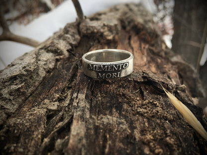 Memento Mori ring on rustic wood
