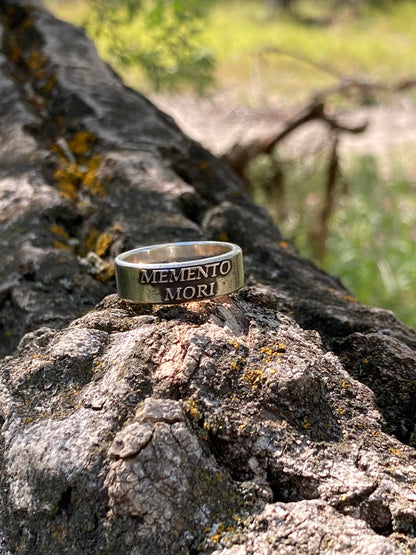 Memento Mori ring on natural wood