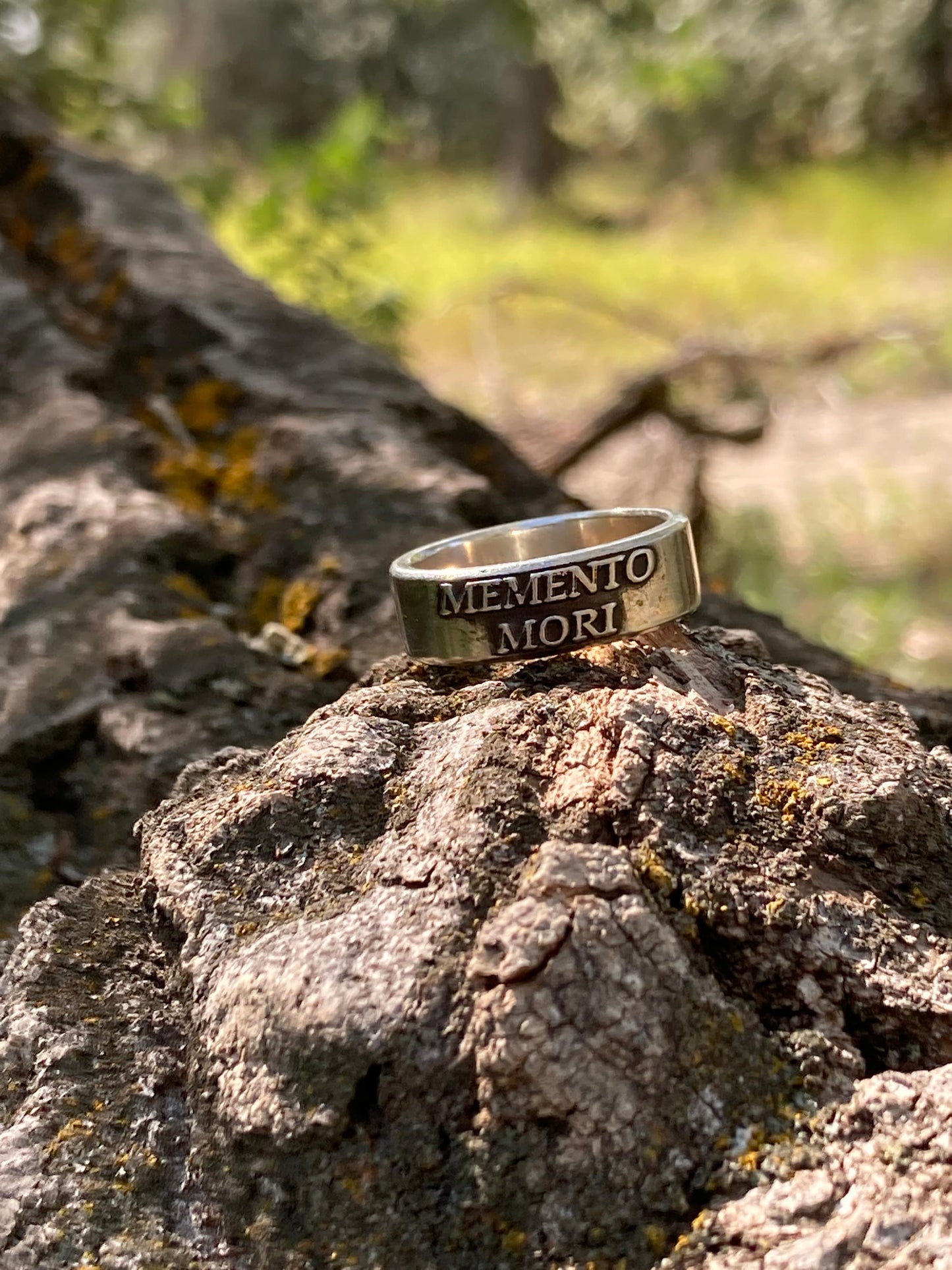 Memento Mori sterling silver ring on tree bark