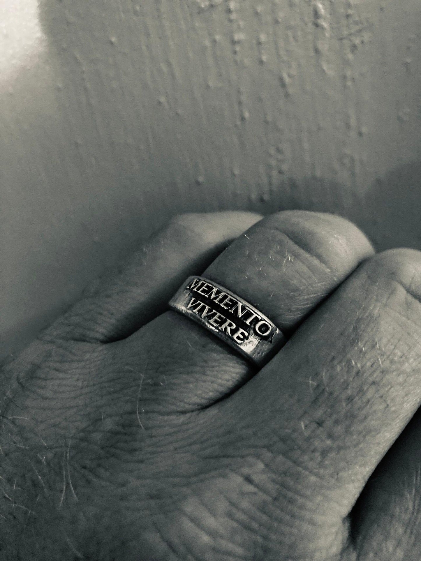 Memento Vivere ring showing antiqued raised lettering