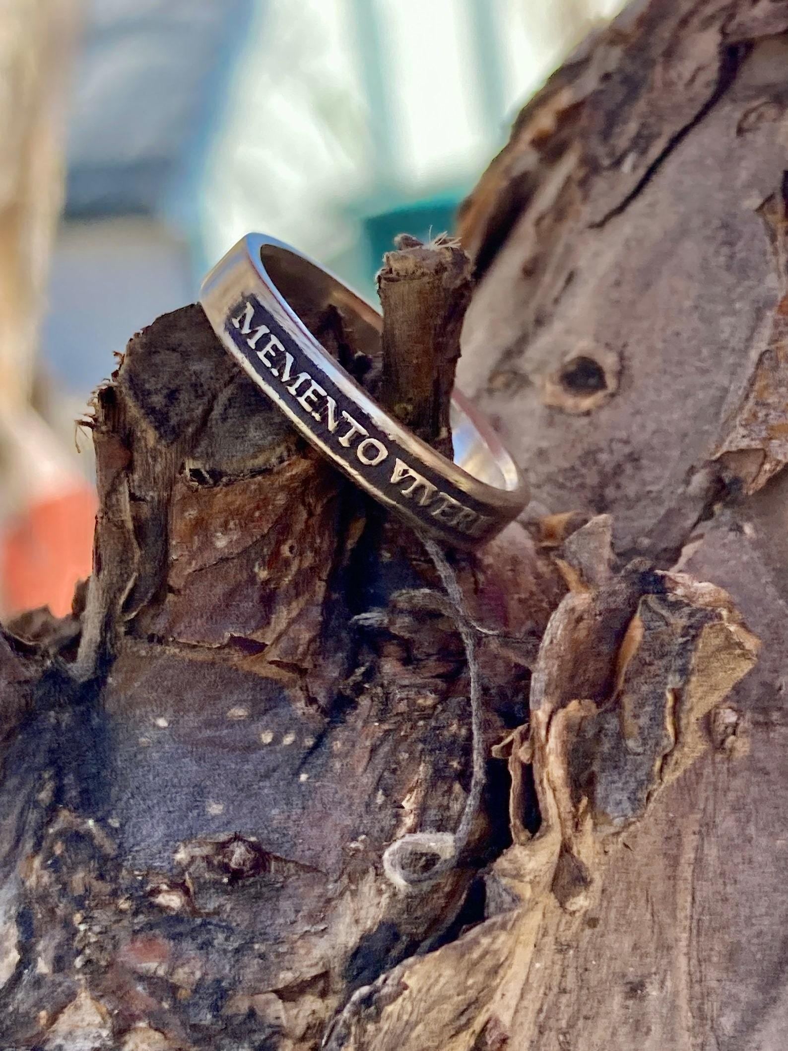 Memento Vivere sterling silver band on weathered wood