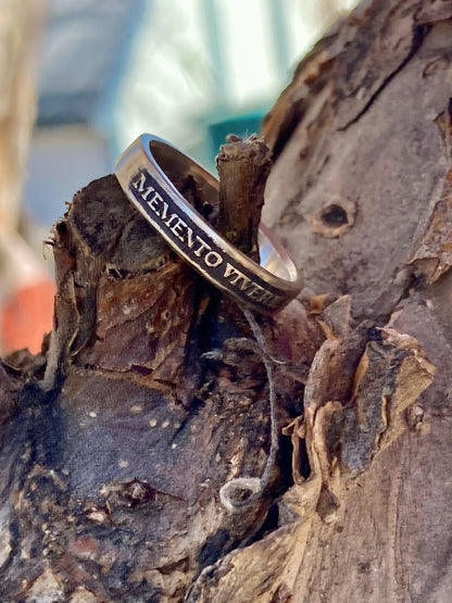 Memento Vivere sterling silver band on weathered wood