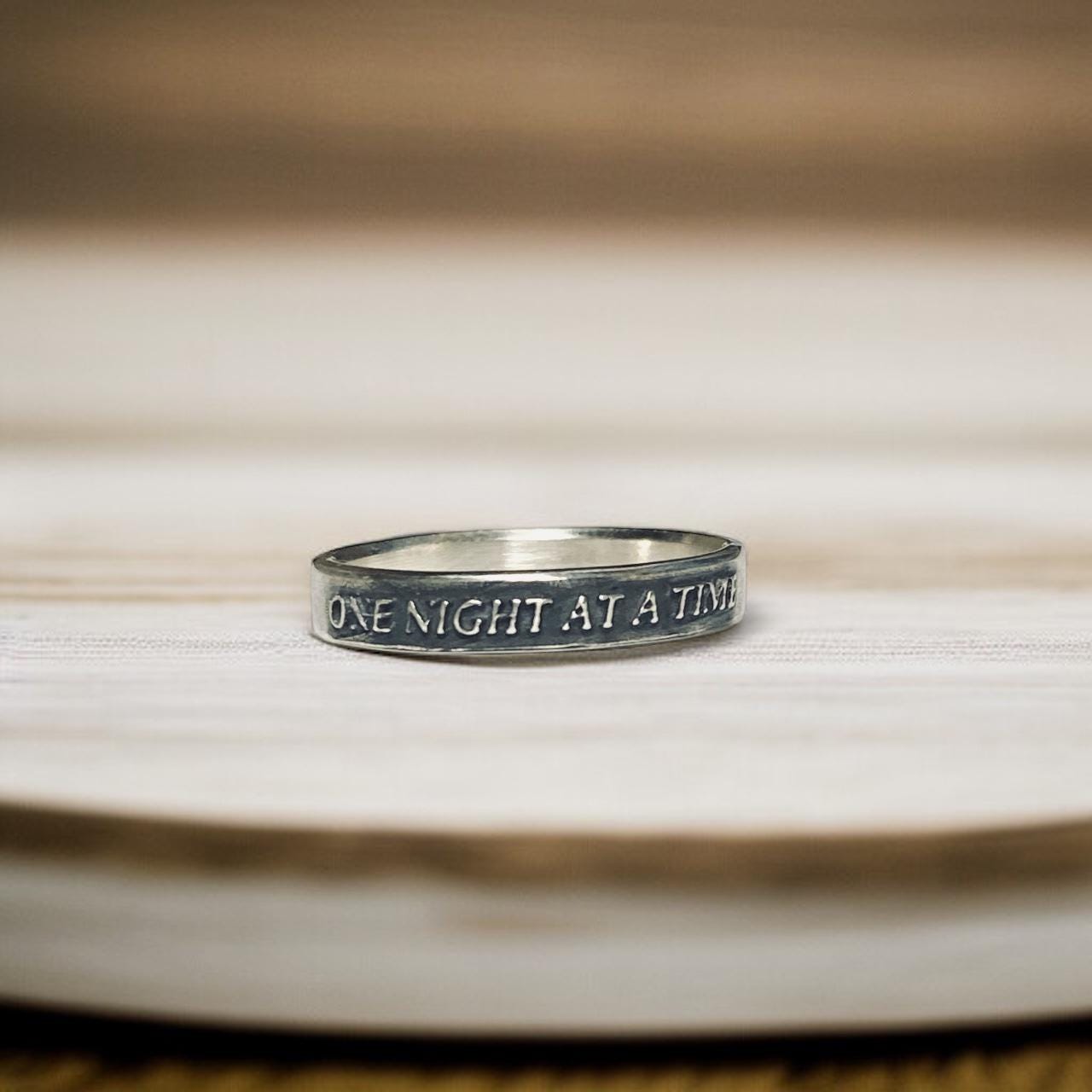 One Night at a Time thin sterling silver ring with raised lettering