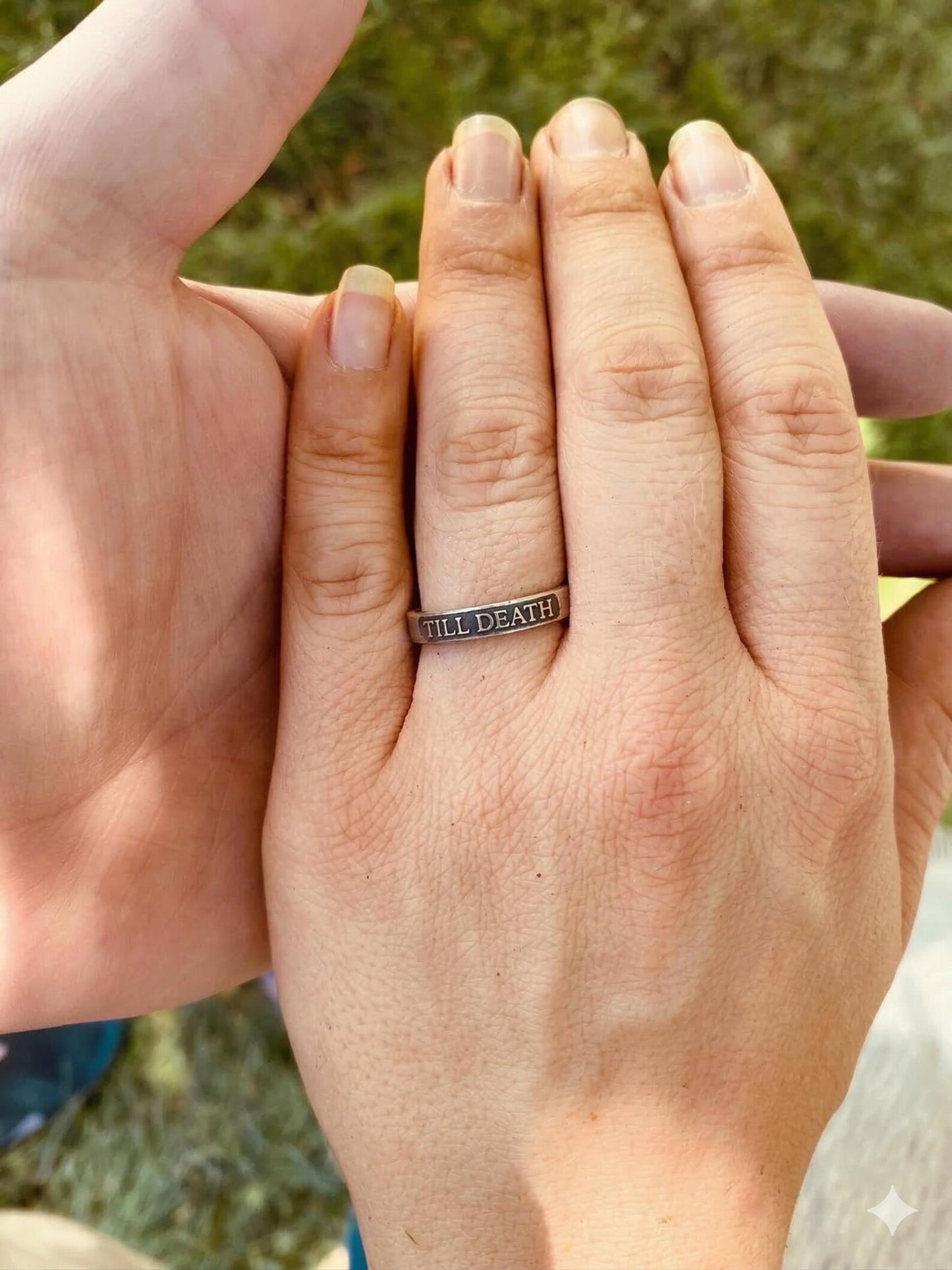 Till Death sterling silver ring worn on a finger