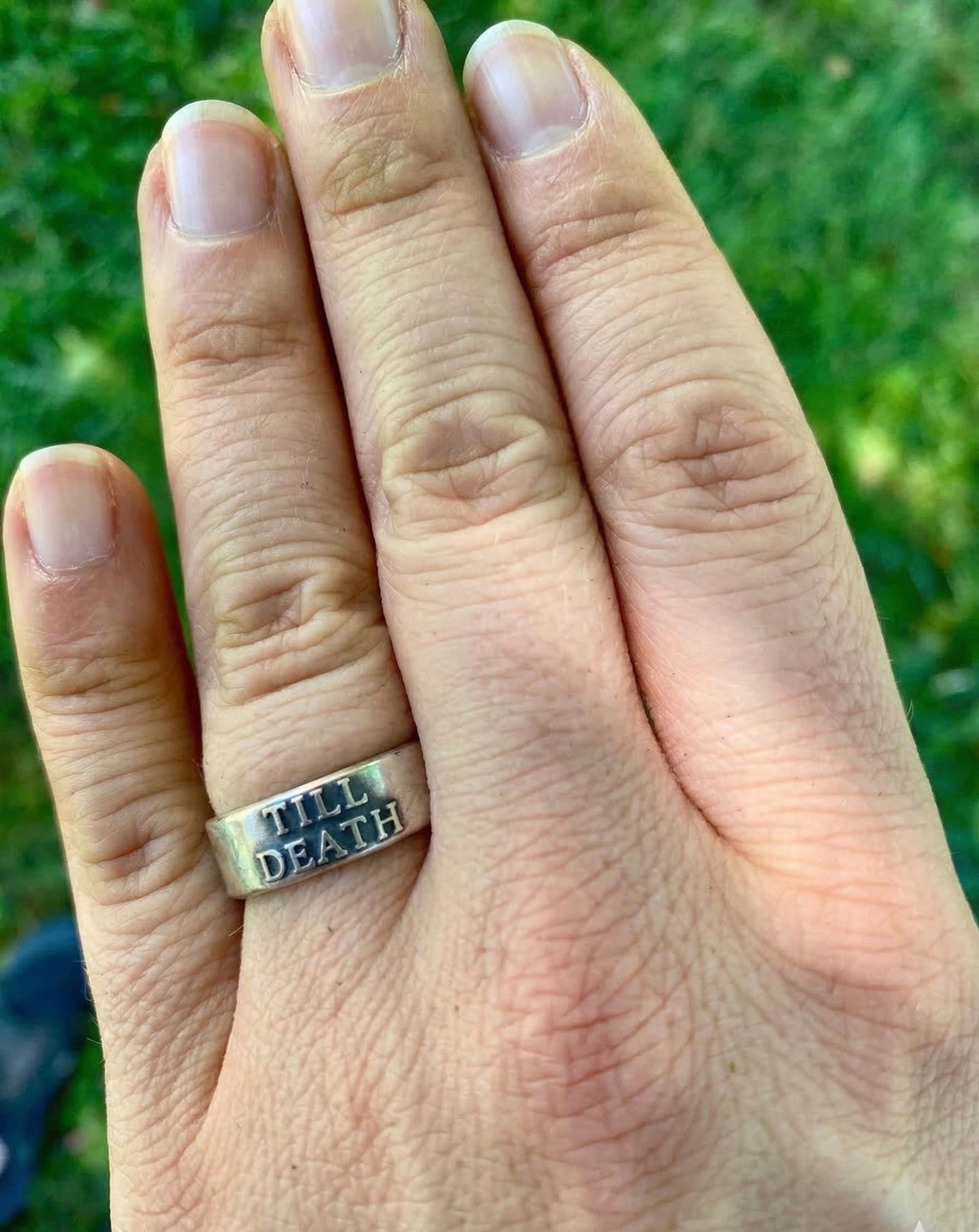 Till Death sterling silver band worn on a hand